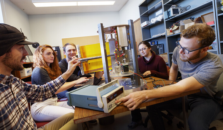 Members of a Nebraska student engineering team work with a space boom tool they helped design and build. Pictured (from left) is Mike Cox, Elizabeth Balerud, Augie McClenahan, Amy Price and Andrew Reicks.