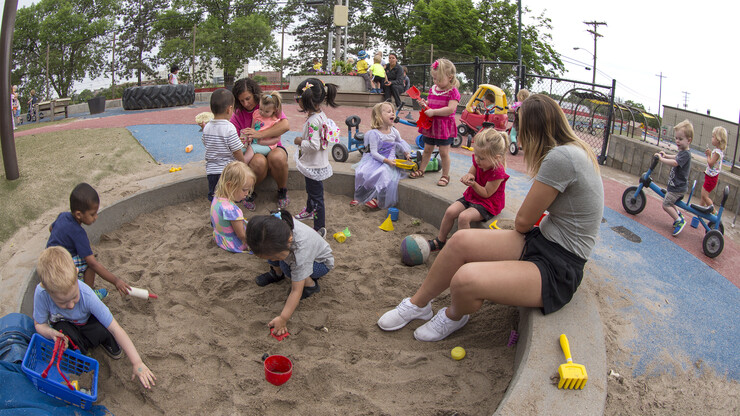 Teachers, staff and children interact on the playground of the university child care facility on the north side of the Prem S. Paul Research Center at Whittier School on June 4. The center has been at Whittier since 2009 and offers child care for the kids of faculty, staff and students.