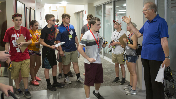 Ken Dewey (right), professor of climatology and director of the University of Nebraska-Lincoln National Weather Camp, gives instruction to the high school campers before embarking on a tour of Memorial Stadium June 14.