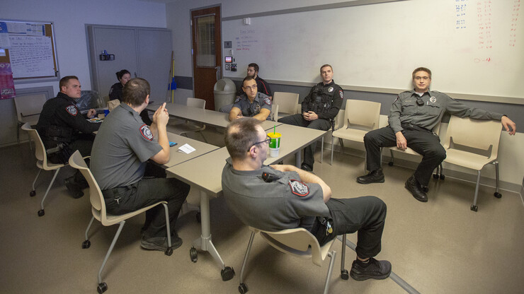 Officers on the University Police Department's third shift meet prior to going out on patrol on Oct. 19. Officers get together to discuss cases and potential threats at the start of each shift.