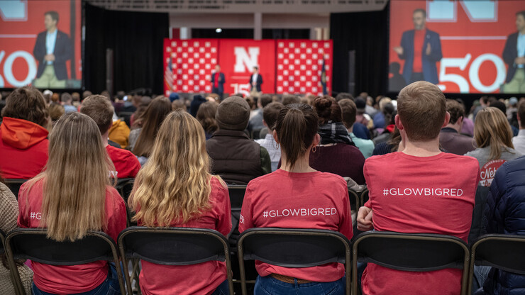 Students herald the Feb. 14 Glow Big Red Charter Week event on T-shirts during the Feb. 11 conversation with Sen. Ben Sasse.