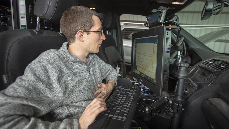 Graduate student Matt Wilson reviews code in programs that are used to collect real-time storm data. All data collected is stored in computers located in the back of Nebraska's mesonet vehicles. The data is backed up daily.