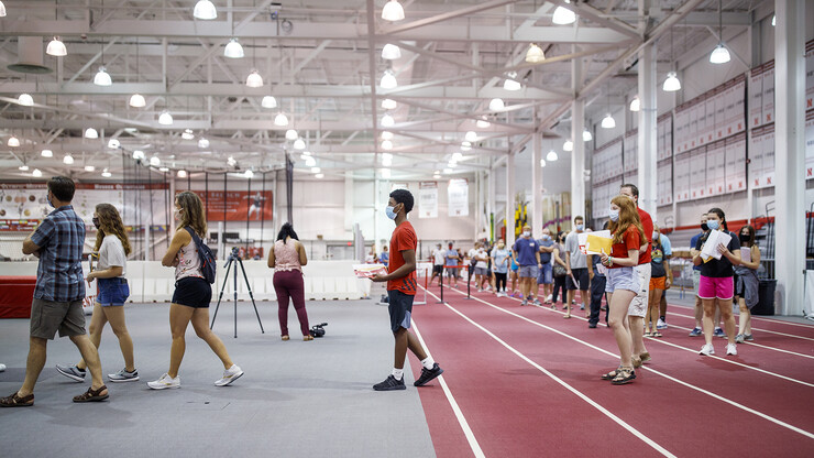 Students social distance as they work their away around the track in Devaney Sports Center to obtain they N Card, complete their paperwork and obtain their check in information. 