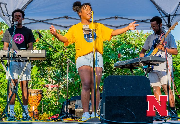 The front cover of the 2021 report features Live Lyve Band, a group of Nebraska students from Rwanda, performing at a community concert that celebrated the end of one of the College of Business’s Global Experience courses last summer.