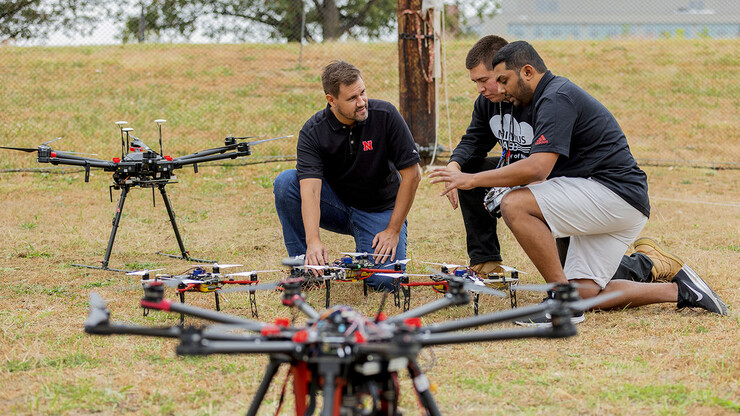Justin Bradley, associate professor of computer science and engineering, discusses unmanned aerial vehicles with graduate students Daniel Rico and Chandima Fernando at the NIMBUS lab on Nebraska Innovation Campus on Oct. 6.