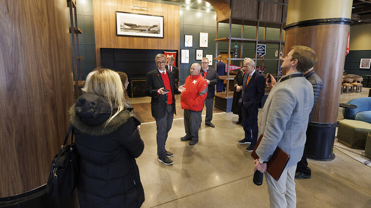 Chancellor Ronnie Green talks about the new Scarlet Hotel on Nebraska Innovation Campus as the group tours the lobby.