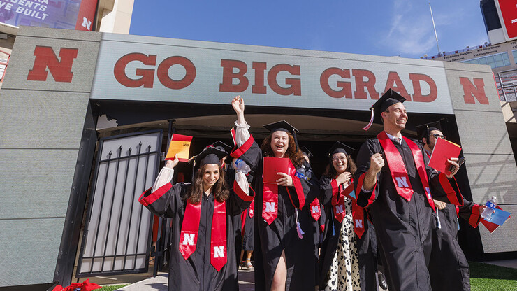Graduates enter the field through the northwest tunnel to find their seats for the undergraduate commencement ceremony May 14 at Memorial Stadium.