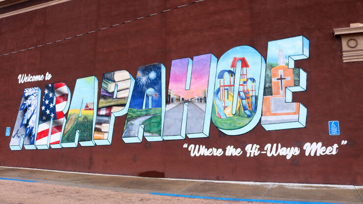 A mural that says "Welcome to Arapahoe: Where the Hi-Ways Meet."