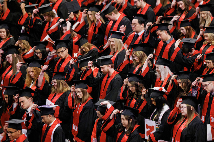 Graduates move their tassels from right to left to signify their graduation during the undergraduate commencement ceremony.