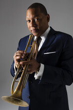 Color portrait of Wynton Marsalis holding a trumpet