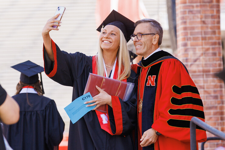 Taylor Peter takes a selfie with Chancellor Ronnie Green after receiving her Bachelor of Science in Animal Science during the undergraduate commencement ceremony May 20 at Memorial Stadium.