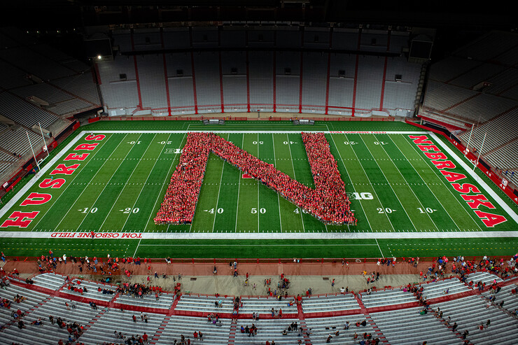 Husker students form a giant red N on the field at Memorial Stadium.