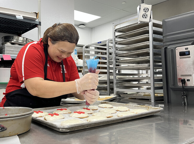 Diemhong Tran, team leader at the East Campus Dining Center, baked and decorated 500 cookies to be given away the first day of classes.