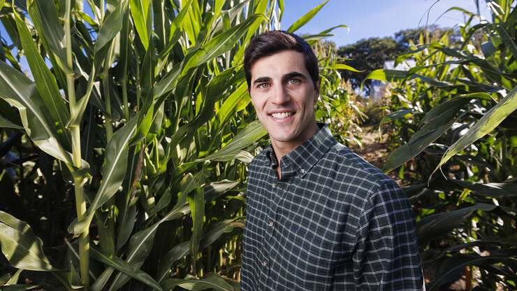 Walter Carciochi, a postdoctoral research associate in agronomy and horticulture at Nebraska, stands amid corn plants.
