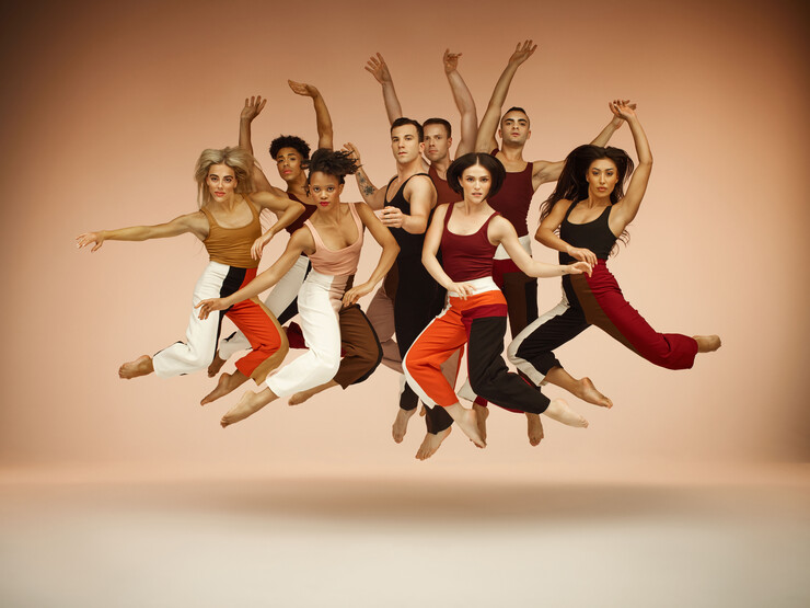Eight dancers strike poses in mid-air.