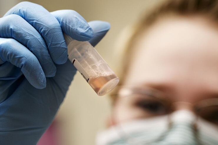 Tristan Kleinschrodt looks at a sample being tested to see if it is human blood in the UNL Crime Lab.