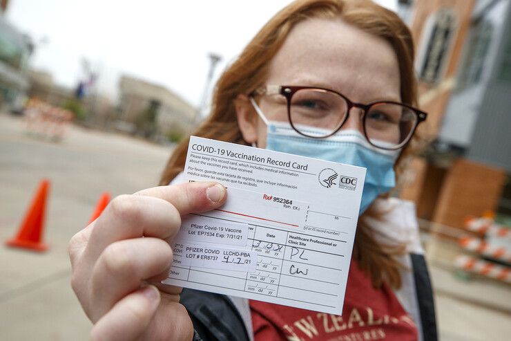 Heather Hunt, a senior animal science major, shows off her vaccine card after receiving her second shot earlier this week. More than 120 university employees helped at the vaccine clinics at Pinnacle Bank Arena on April 7-9.