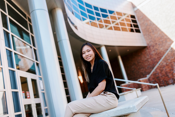 Chau Nguyen sits outside of the Jackie Gaughan Multicultural Center.