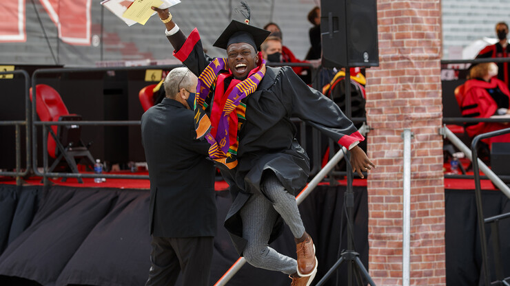 Nebraska Business grad DeShawn McGary jumps for joy after receiving his degree in Memorial Stadium during spring 2021 commencement. The undergraduate ceremony returns to the university’s iconic stadium in May.