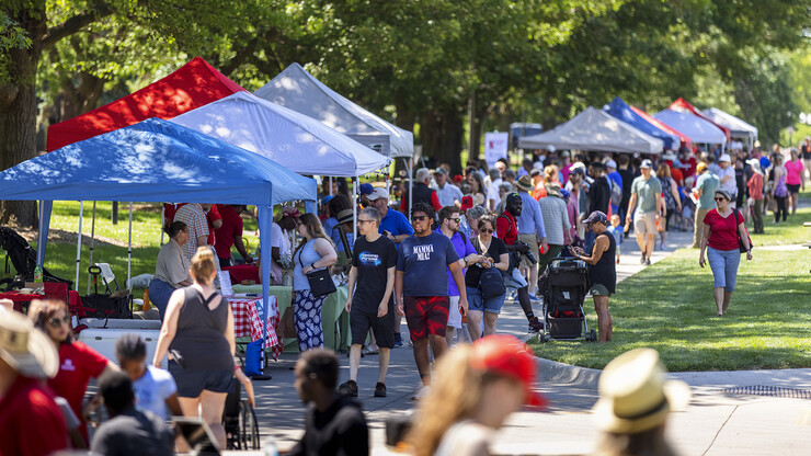 Visitors walk along the line of vendors during East Campus Discovery Days on June 12.