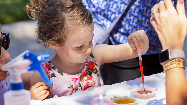 A child makes hydrogel bubbles within a liquid during East Campus Discovery Days on June 12.
