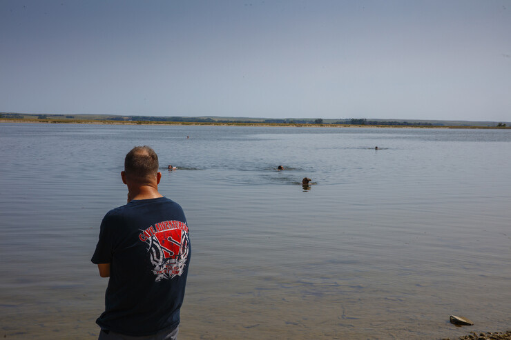 Students dive in Lake Olgallala under the watchful eye of Bill Belcher, assistant professor of anthropology.