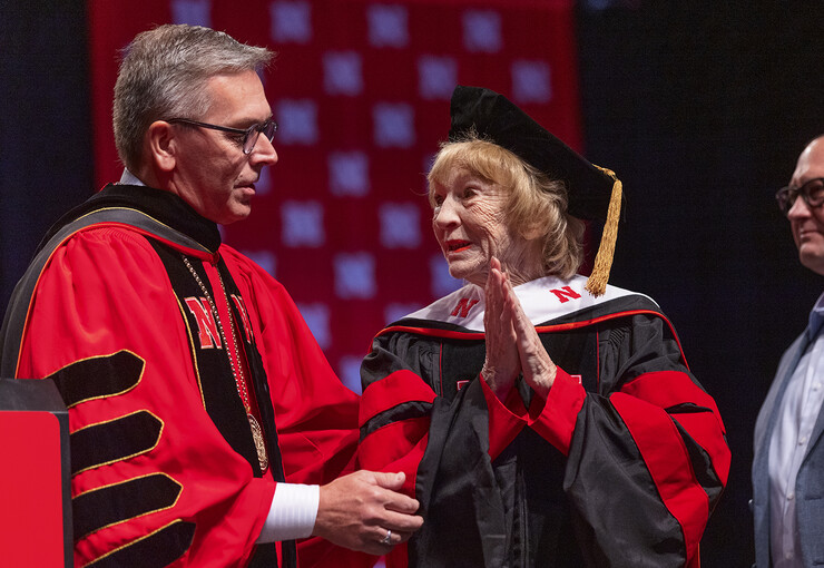 Chancellor Ronnie Green talks with Leta Powell Drake during the degree presentation in Pinnacle Bank Arena on Aug. 14.
