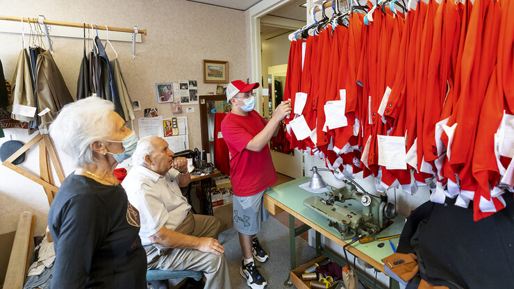 Demetrios Delgiannis and his wife Stamatia watch as Alfonso Meza picks up his altered uniform pants on Sept. 1. This year, each member of the band received new pants for the season. Each of the 300 pairs was custom tailored by the couple.