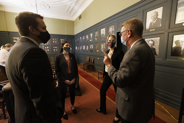 Ryan Sullivan, clinical associate professor of law (left), and Kevin Ruser, professor of law and director of clinical programs (right), talk with Barth and Dick after their arguments were finished Feb. 4.