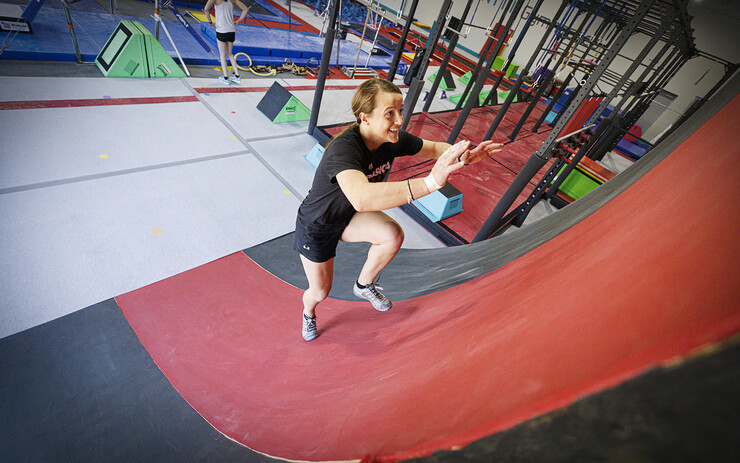 Leigh Jahnke runs up a warped wall while practicing in Lincoln to take part in the American Ninja Warrior series.