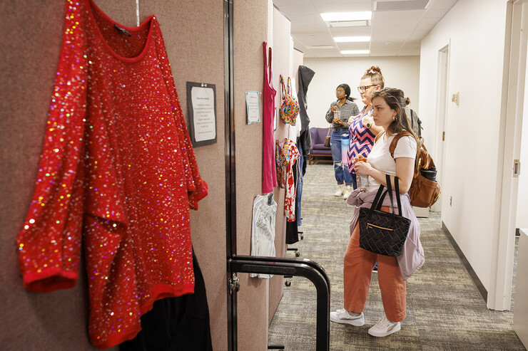 Graduate students Elyxcus Anaya and Jessica Boyles examine the “What Were You Wearing?” survivor art installation in the new CARE space within Neihardt Center on April 12. The display featured recreations of outfits worn by those who were sexually assaulted with accompanying stories from the survivors. It was shown in Neihardt Center as a way for Huskers to see the space CARE will move into during the summer.