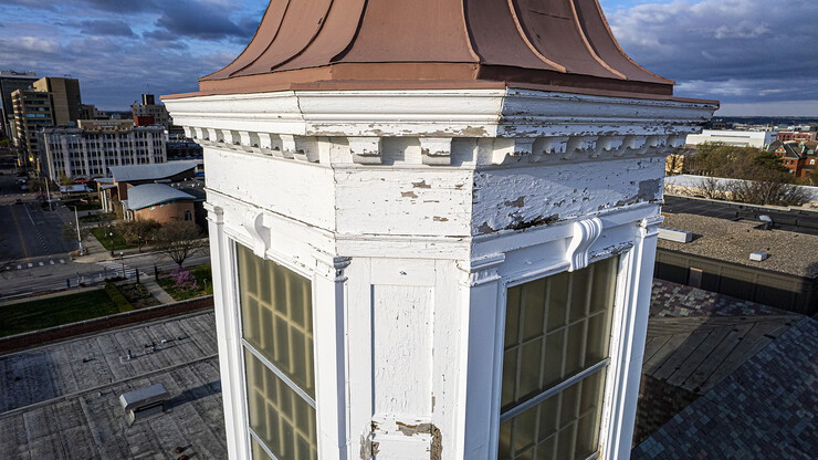Detail showing chipped paint and water damage to the exterior of the Love Library cupola.