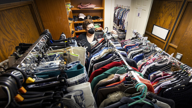 JD McCown, Assistant Director of the LGBTQA+ Center, arranges donated clothing the in the Lavender Closet June 6.