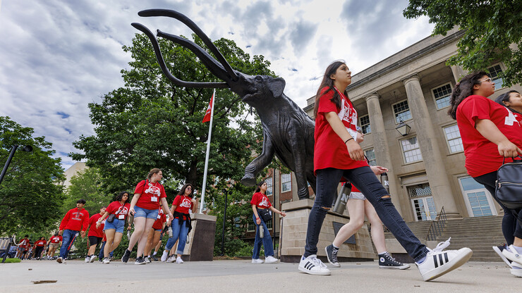 Junior-year NCPA scholars stroll by Archie the mammoth on the way to a College of Engineering session on June 8. The scholars toured facilities in engineering, law, business, and journalism and mass communications.