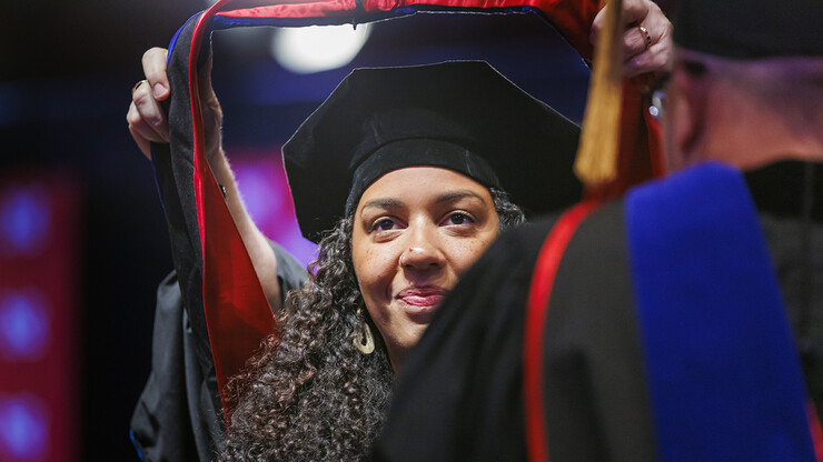 Megan Cardwell is hooded during the ceremony. Megan, the first-born, also received her hood first.