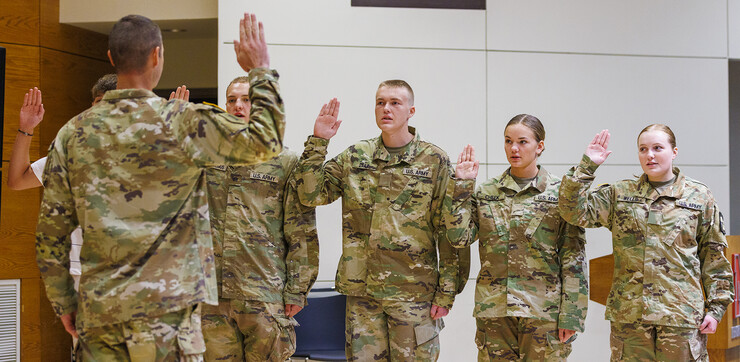 Lt. Col. Mark Peer (front, left) gives the oath to (from left) freshman Nicholas Law, and sophomores Christopher Nicodemus, Kolby Daily, Jocelyn Cheek and Rianna Wells. The Aug. 19 ceremony in the Nebraska Union’s Swanson Auditorium concluded the contracting that allows ROTC cadets to receive full-scholarship benefits. 