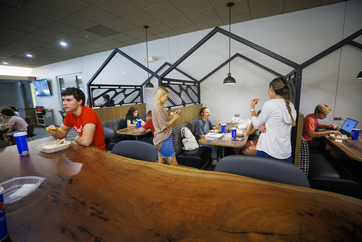 Livi Swanson, a freshman from Lincoln, talks with friends as she eats in one of the new seating areas in Selleck Dining Hall