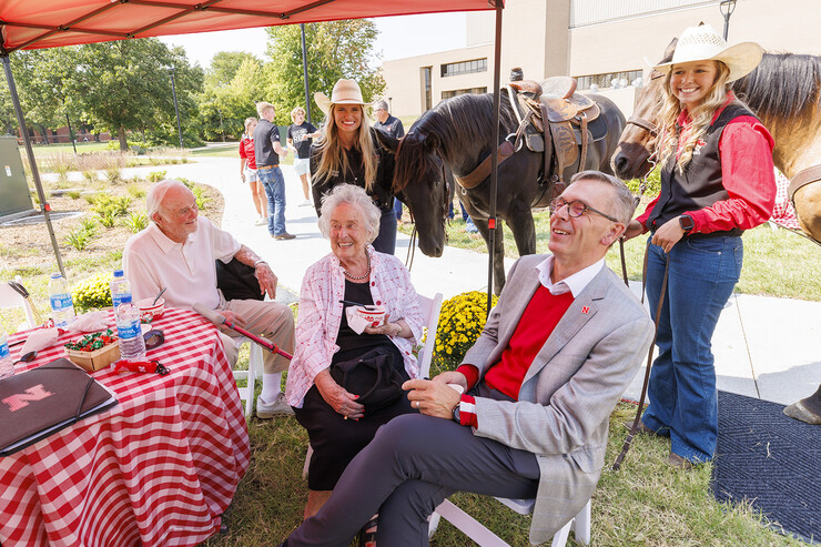 Bill and Ruth Scott, Chancellor Ronnie Green and UNL Rodeo Club members Hallie Reeves (left) and Sydney Veldhuizen share a laugh during the Sept. 14 unveiling and celebration of the George Beadle sculpture outside the Dinsdale Learning Commons.
