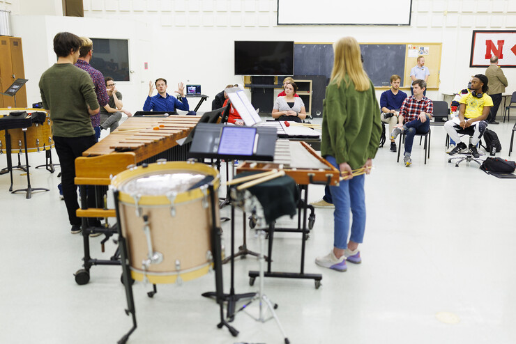 David Skidmore with Third Coast Percussion, left, talks with students in a percussion class.