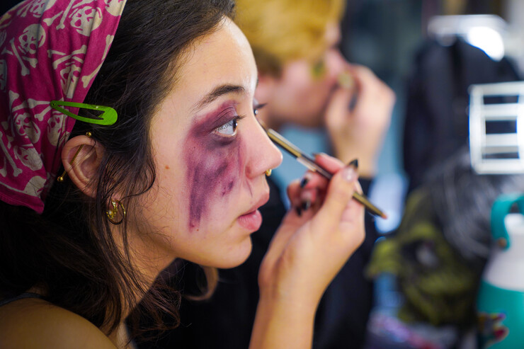 Aurora Villarreal applies stage makeup before the Shakesfear Haunted house on Oct. 12, 2022