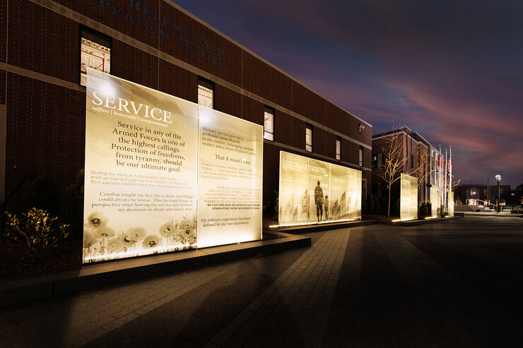 Image of glass panels in the Veterans' Tribute at dawn. Michelle Waite helped lead the charge for the inclusion of the tribute on campus.