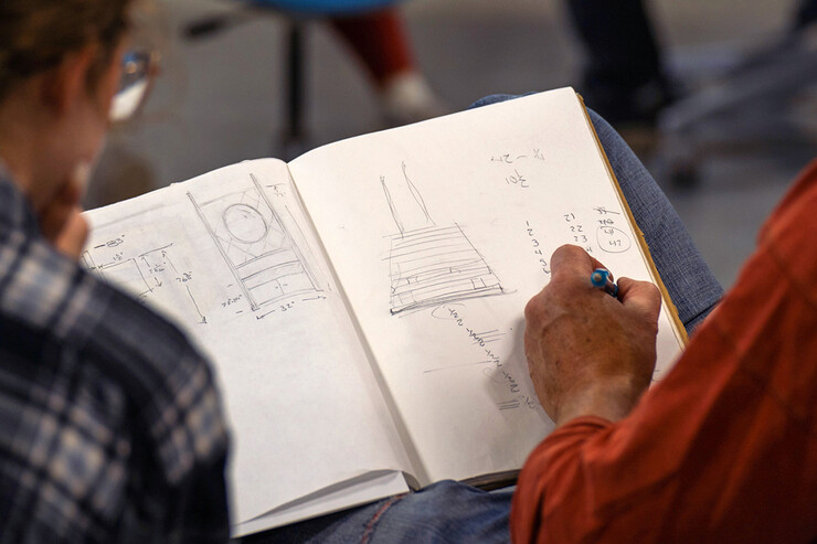 Iowa State professor Chris Martin provides a sketch idea to a student.