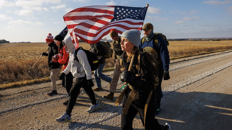 Student-veterans and volunteers walk along a rural Lancaster County road towards Eagle during the first leg of the Things They Carry Ruck March on Nov. 16. The Nebraska team will carry the game ball over 150 miles before handing it off to the Iowa team on Nov. 20.