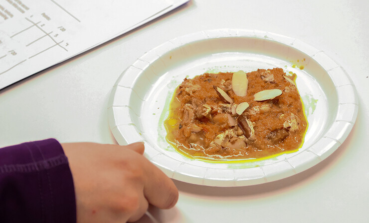 The winning entry, Indian Carrot Porridge, is plated and presented for the judges.