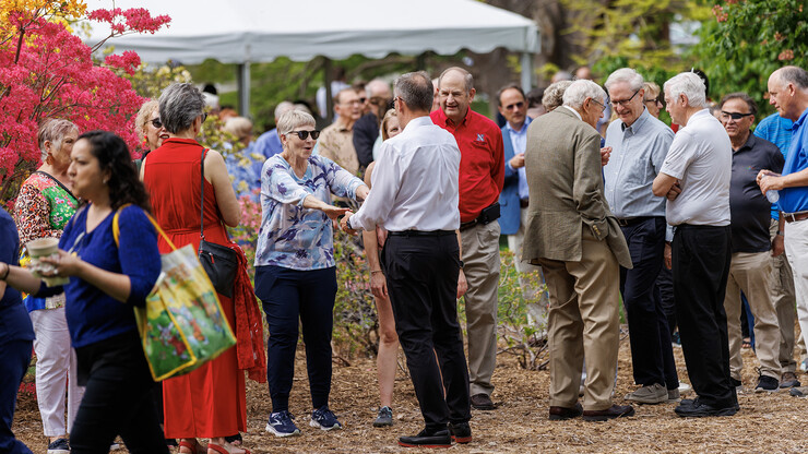 Maurenn Burson greets Chancellor Ronnie Green during the May 11 celebration. Burson is part of a group that traveled alongside the Greens during a mission trip to El Savador. 