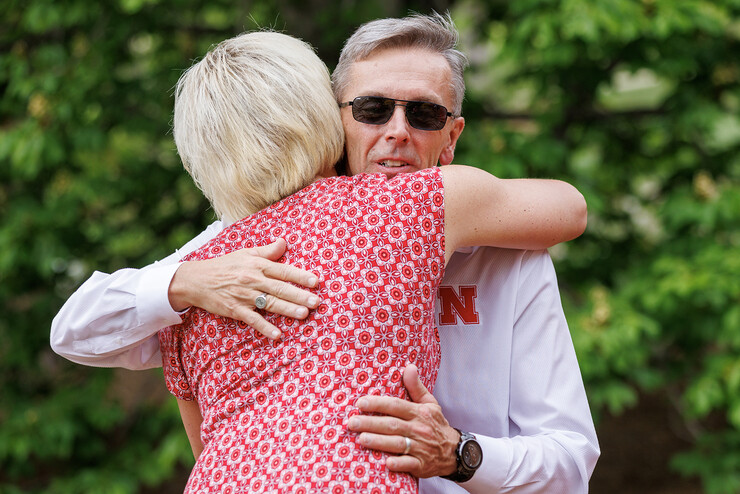 Ronnie Green is hugged by Lisa Kaslon, an extension educator with Nebraska Extension, during the May 11 event.