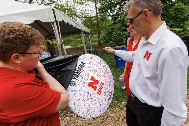 Carolyn Barber, Ron and Carol Cope Professor of Music and director of bands, presented the Greens with a drumhead signed by members of the Cornhusker Marching Band.