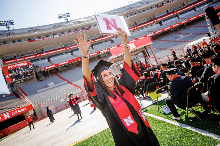 Isabel Adrover Gallego celebrates after receiving her degree May 20 in Memorial Stadium.