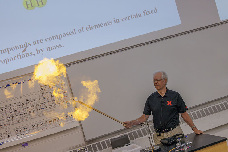 Richard Hartung capped his first Chemistry 109 lecture with a bang as he exploded a balloon filled with a H2O2 gas and lighted it using a candle taped to along stick