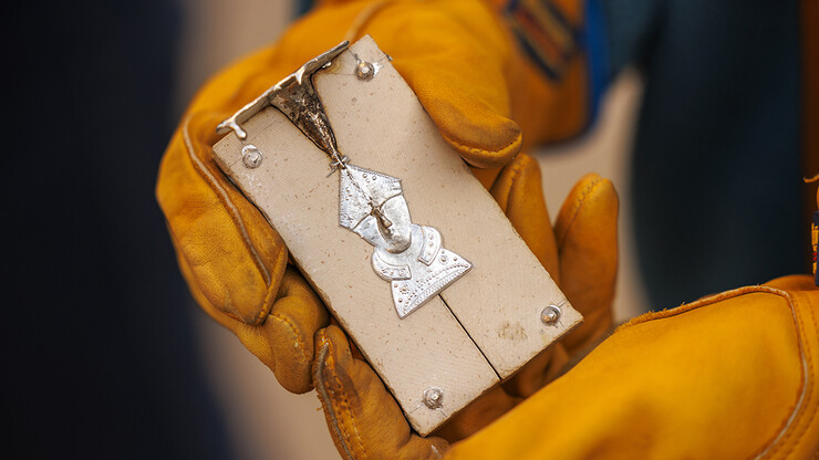 A pilgrim's badge of Thomas Becket, former Lord High Chancellor of Great Britain, is ready to be removed from the mold.